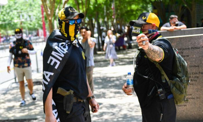 Counter-protesters wearing the yellow-and-black colors and insignia of the Proud Boys gather outside the National Rifle Association (NRA) Annual Meeting at the George R. Brown Convention Center in Houston, Texas, on May 28, 2022. (Patrick Fallon/AFP via Getty Images)
