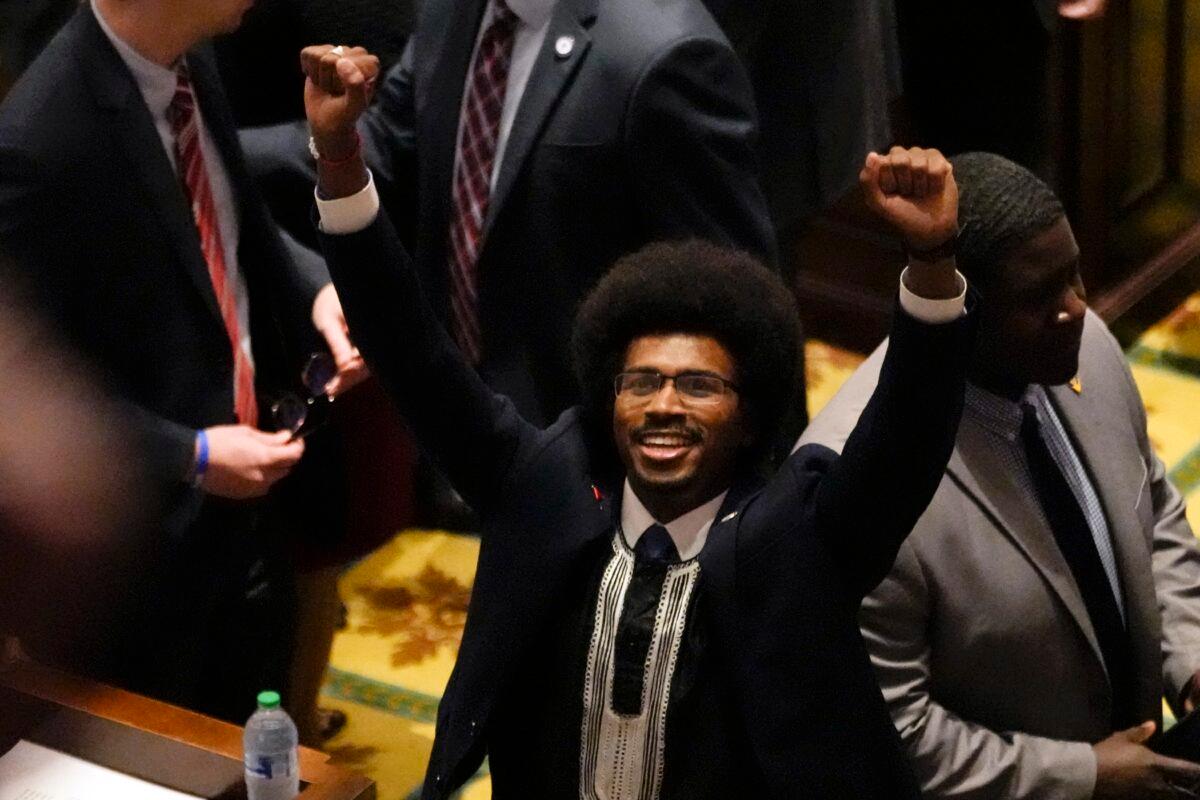 State Rep. Justin Pearson (D-Memphis) raises his fists on the floor of the House chamber to recognize his supporters before the start of the legislative session in Nashville, Tenn., on April 6, 2023. (George Walker IV/AP Photo)