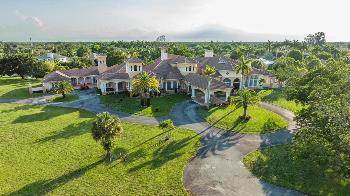 A winding road leads to the sprawling home, which is set on a 3.8-acre lot for maximum privacy. (Courtesy of The Carroll Group)
