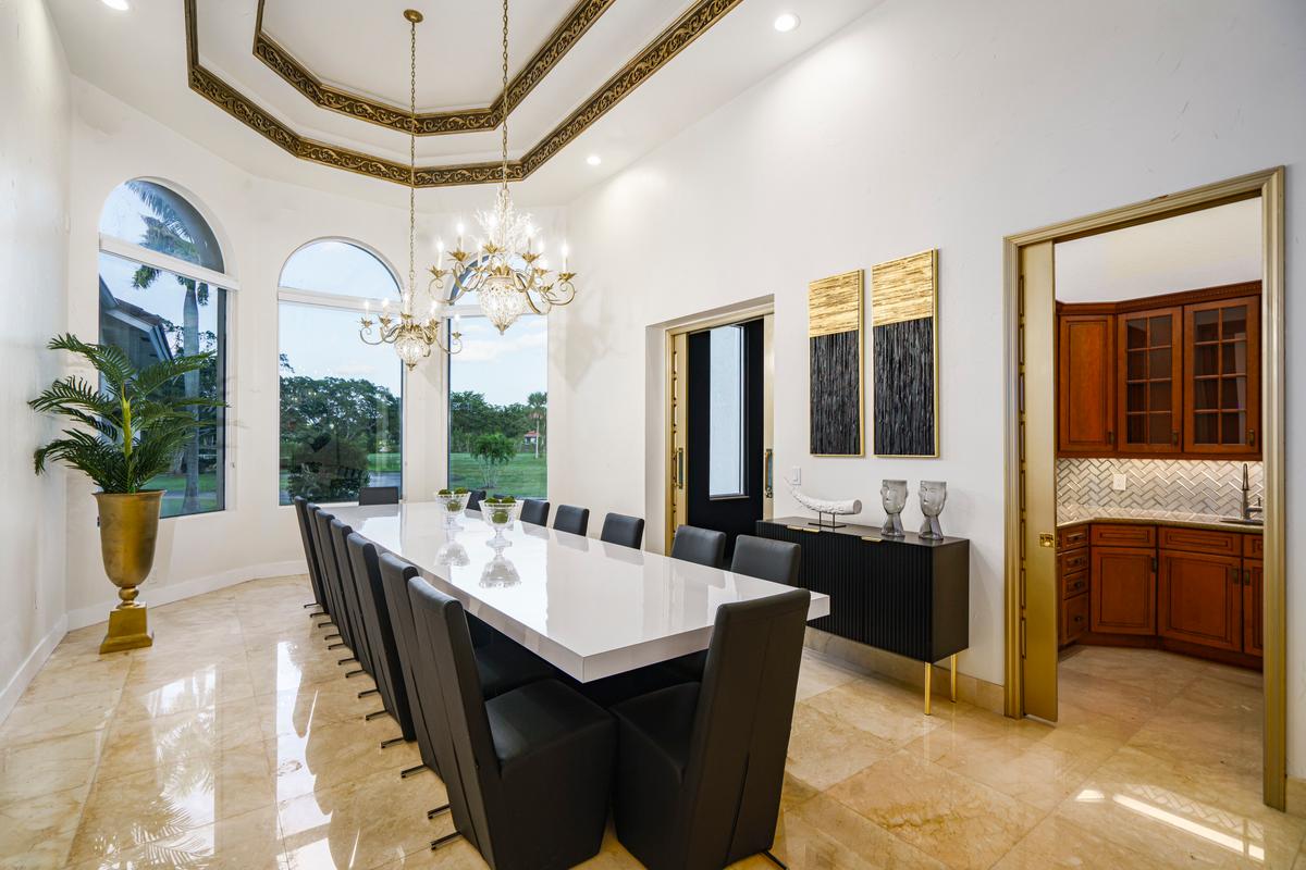 A formal dining room with seating for 12 is located adjacent to the kitchen, which has a sliding door to ensure privacy. (Courtesy of The Carroll Group)