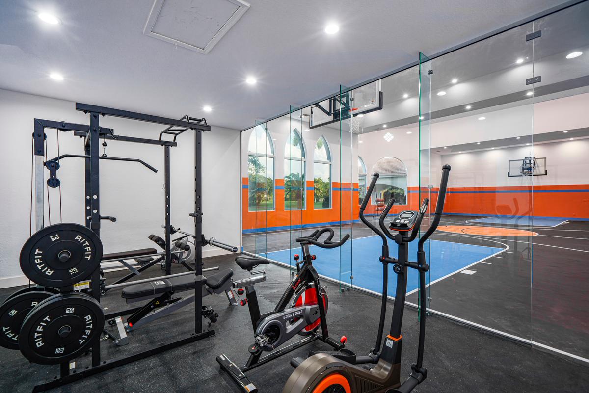 The home is equipped with a full-sized indoor basketball court and a well-equipped fitness center. (Courtesy of The Carroll Group)