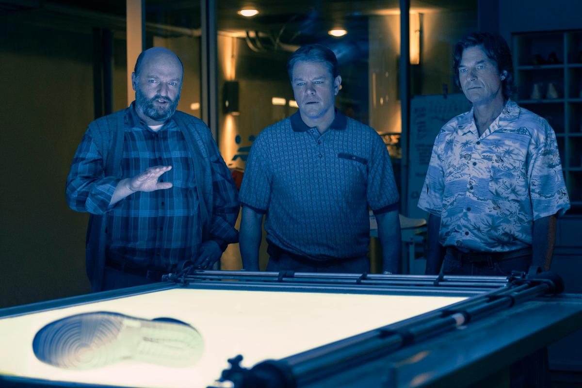 (L–R) Peter Moore (Matthew Maher), Sonny Vaccaro (Matt Damon), and Rob Strasser (Jason Bateman) talk strategy on how to make a magic shoe, in "Air." (Warner Bros. Pictures)