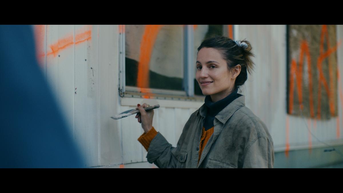 Maggie (Dianna Agron) paints over the graffiti on dad's house, in "Acidman." (Brainstorm media)