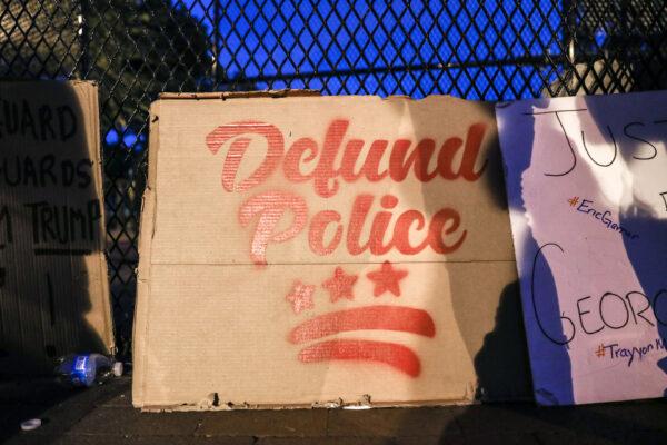 A “Defund the Police” sign during a protest near the White House following the May 25 death of George Floyd in police custody, in Washington on June 6, 2020. (Charlotte Cuthbertson/The Epoch Times)