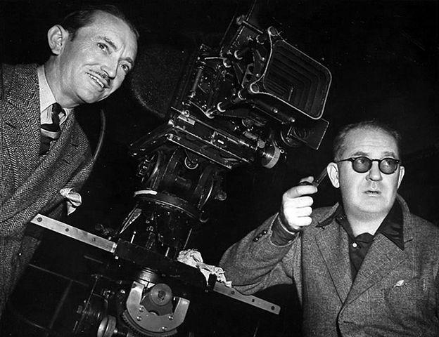 Cinematographer Bert Glennon (L) and director John Ford on the set of “Stagecoach”<br/>in 1939. (Public domain)