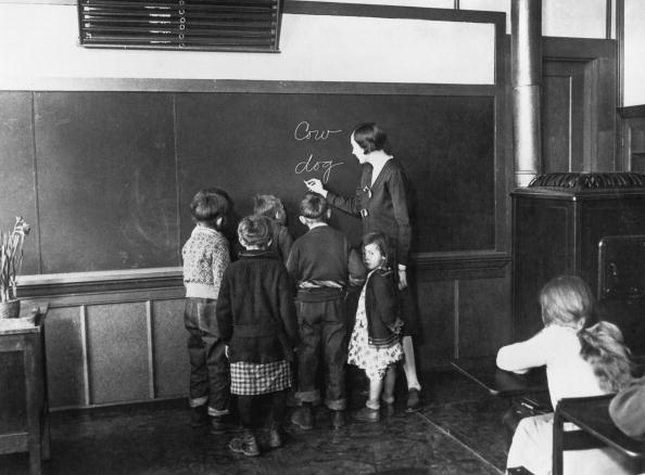 Mann believed that all American kids deserved an education, and that having an educated population was vital for a democracy to survive. A teacher writes on the blackboard to teach her young pupils how to spell, 1930. (FPG/Hulton Archive/Getty Images)