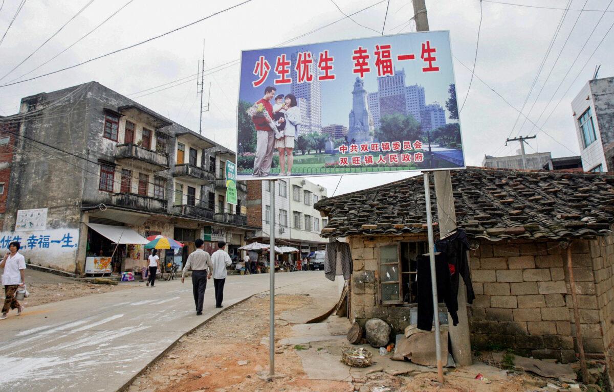 A one-child policy billboard saying, 'Have fewer children, have a better life,' greets residents on the main street of Shuangwang, in southern China's Guangxi region, in May 2017. (Goh Chai Hin/AFP via Getty Images)