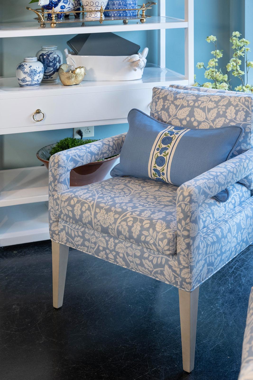 Swirling vines with leaves are repeated in the fabric of the Vallone chair, the tape trim on the pillow, and on the blue and white accessories on the shelving. (Handout/TNS)