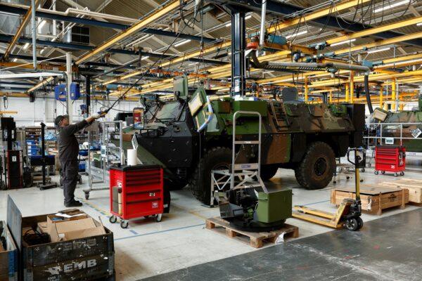 Employees work on the assembly line of the VAB armored personnel carrier vehicles at the Arquus military vehicle production plant, a unit of Volvo AB, in Limoges, France, on April 6, 2023. (Benoit Tessier/Reuters)