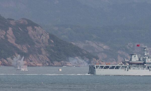 A Chinese warship fires at a target during a military drill near Fuzhou, Fujian Province, near the Taiwan-controlled Matsu islands that are close to the Chinese coast on April 8, 2023. (Thomas Peter/Reuters)