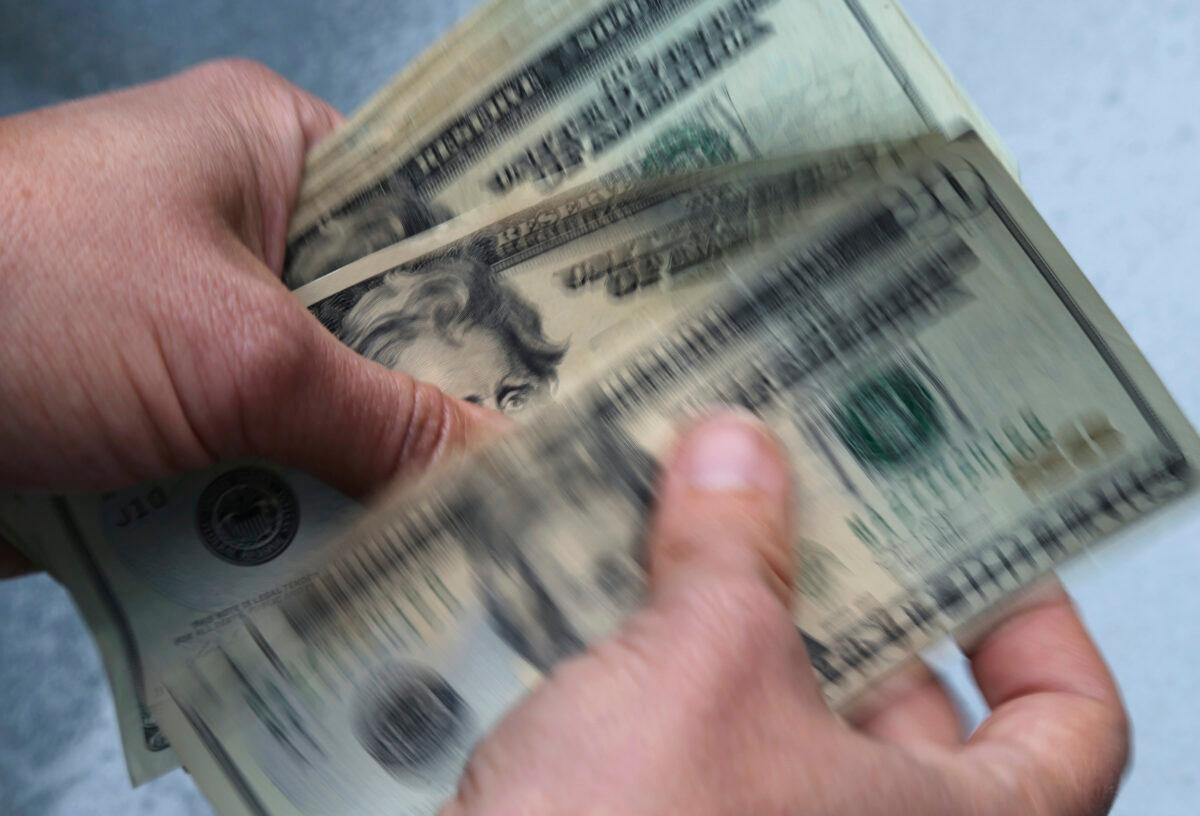 Twenty dollar bills are being counted. (Elise Amendola/AP Photo)