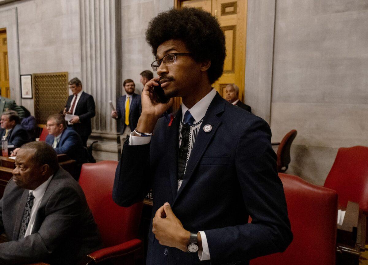 Tennessee Rep. Justin Pearson speaks on his phone while being expelled from the state Legislature in Nashville, Tenn., on April 6, 2023. (Seth Herald/Getty Images)
