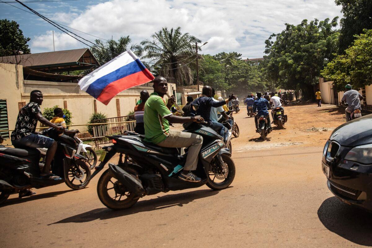A supporter of Capt. Ibrahim Traore, the leader of Burkina Faso, waves a Russian flag in the streets of Ouagadougou, Burkina Faso, on Oct. 2, 2022. (Sophie Garcia/AP Photo)