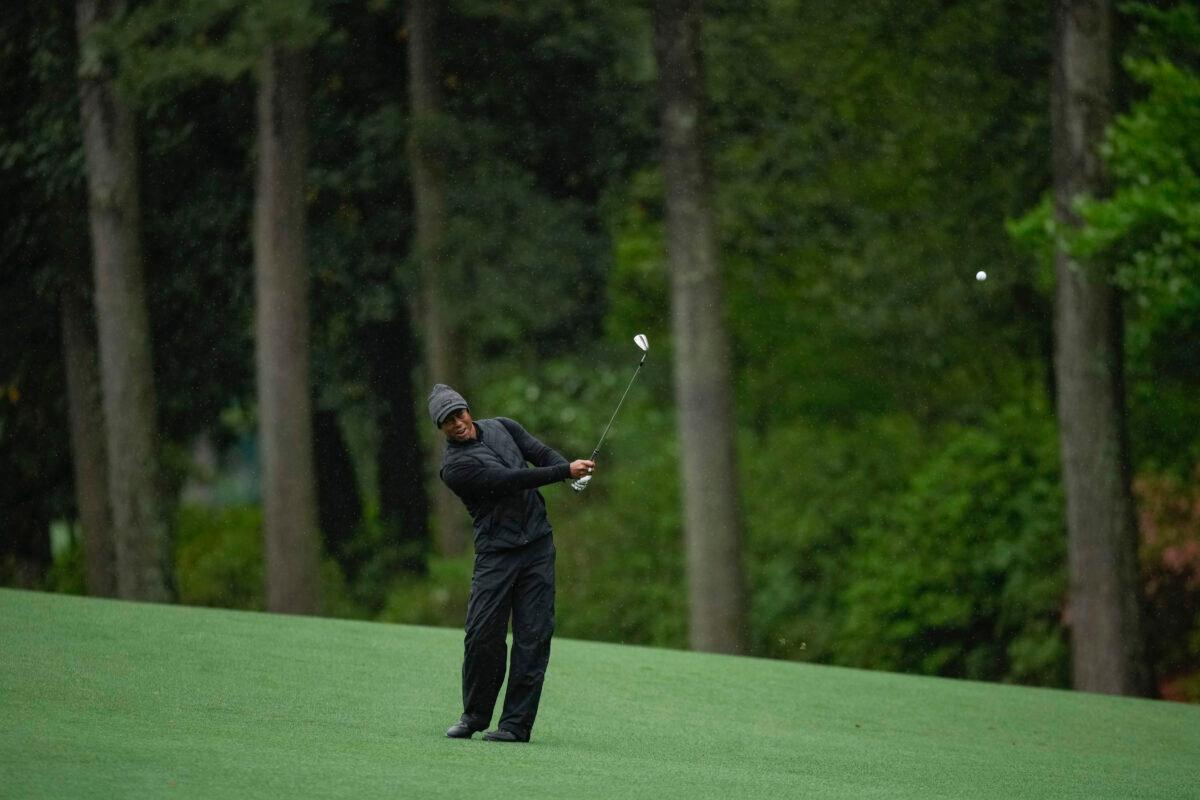 Tiger Woods chips to the green on the 13th hole during the weather delayed third round of the Masters golf tournament at Augusta National Golf Club in Augusta, Ga., on April 8, 2023. (AP Photo/Matt Slocum)