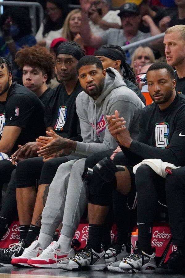 Los Angeles Clippers' Paul George, in grey, sits on the bench during the second half of an NBA basketball game against the Portland Trail Blazers in Los Angeles on April 8, 2023. (Mark J. Terrill/AP Photo)