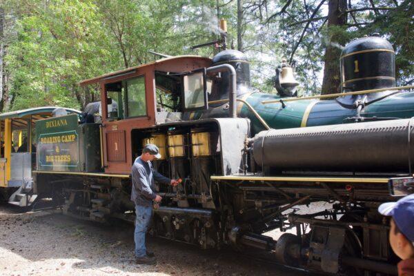 A fireman checks the workings of the Dixiana steam locomotive. (Courtesy of Karen Gough)