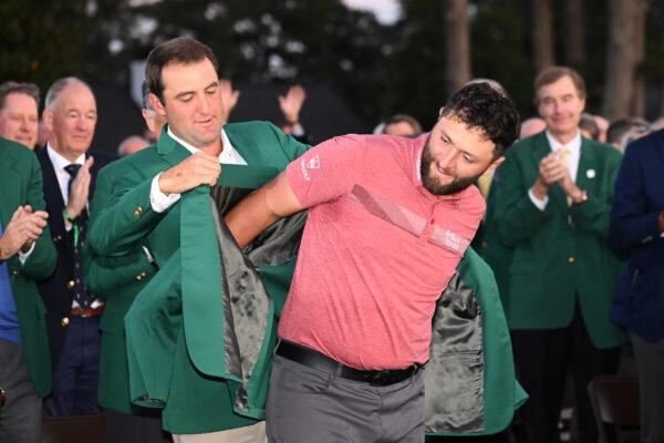 Scottie Scheffler of the United States puts the green jacket on Jon Rahm of Spain after he won the 2023 Masters Tournament at Augusta National Golf Club in Augusta, Ga., on April 9, 2023. (Ross Kinnaird/Getty Images)