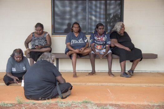 Walpiri community members wait to meet coroner Elisabeth Armitage at the local police station in the outback community of Yuendumu, northwest of Alice Springs, Australia, on Nov. 15, 2022. (AAP Image/Aaron Bunch)