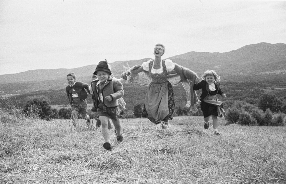 Mary Martin with children in mountain landscape. Martin played the leading role, Maria, in the Broadway musical The Sound of Music. (Toni Frissell)