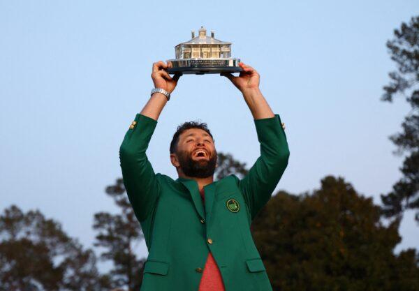 Spain's Jon Rahm celebrates with his green jacket and the trophy after winning The Masters in Augusta, Ga., on April 9, 2023. (Mike Segar/Reuters)
