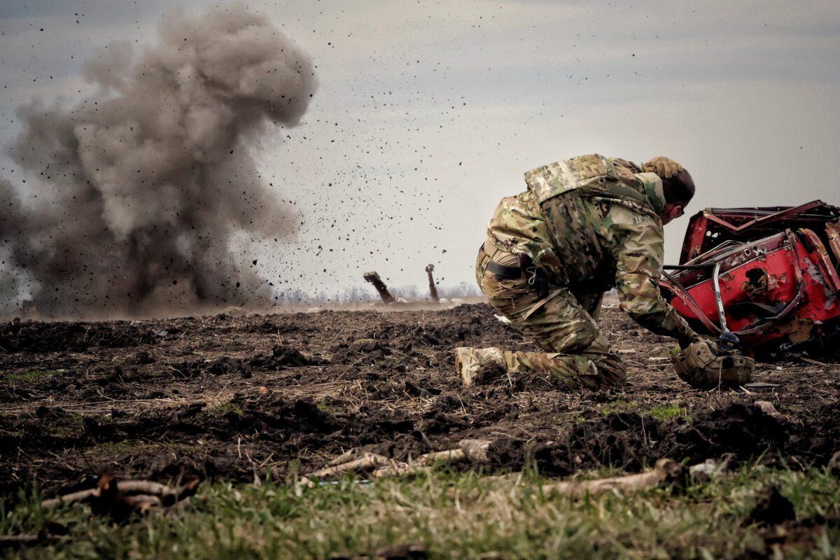 A Ukrainian serviceman reacts as he throws a grenade during training, amid Russia's invasion of Ukraine, in the Donbas region, Ukraine, on April 8, 2023. (Yan Dorbronosov/Reuters)