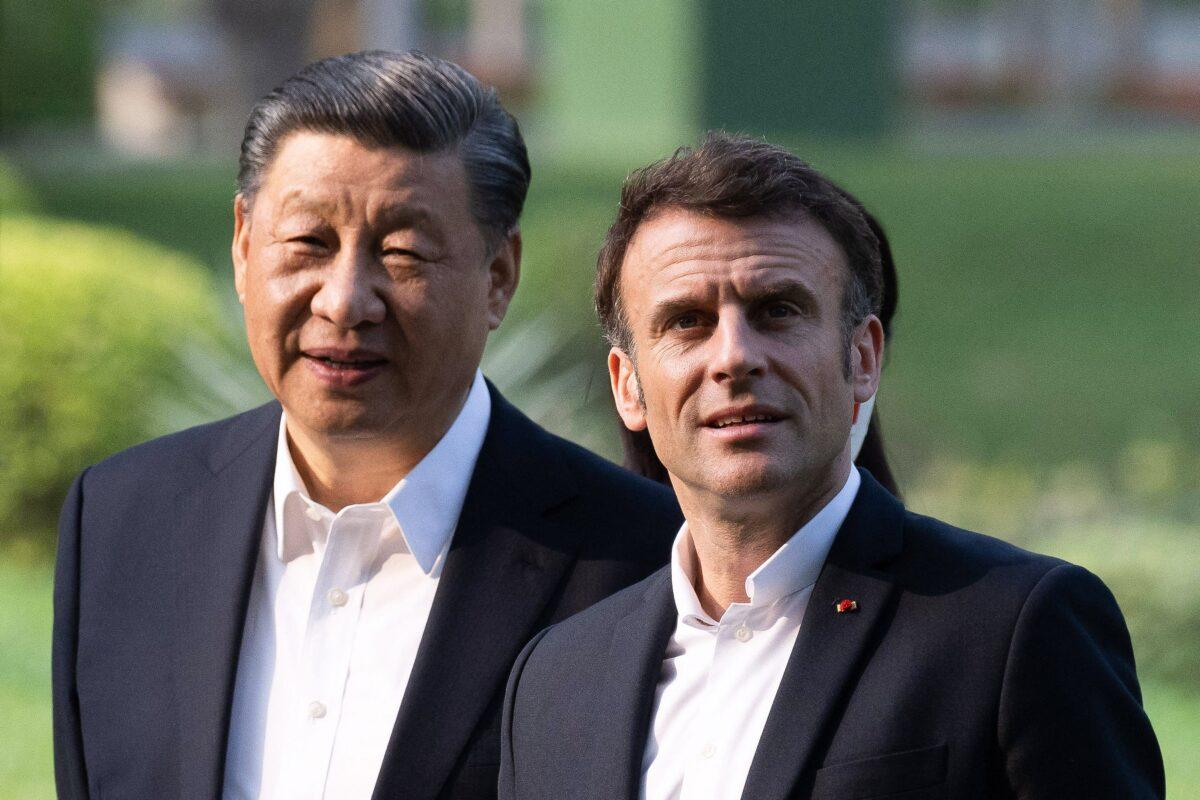 Chinese leader Xi Jinping and French President Emmanuel Macron visit the garden of the residence of the governor of Guangdong, in China, on April 7, 2023. (Jacques Witt/Pool/AFP via Getty Images)