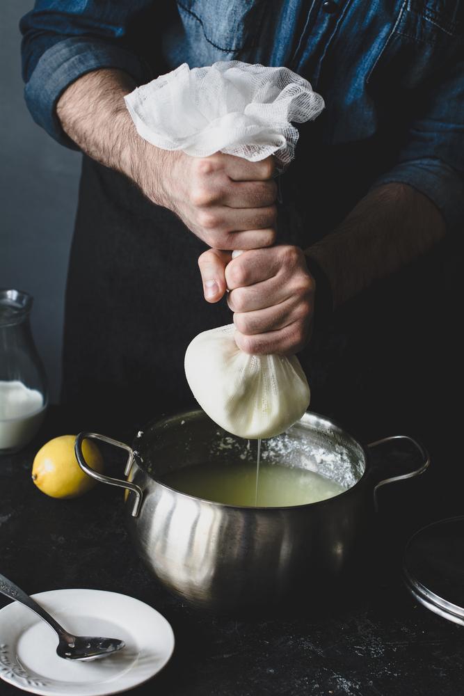 After curdling milk with your acid of choice, you'll need cheesecloth to strain the whey. (Vladislav Noseek/Shutterstock)