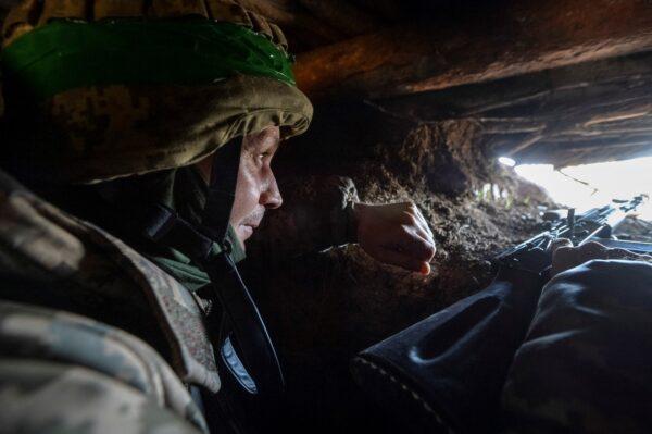 A Ukrainian service member in a trench at a position on a frontline near the city of Bakhmut, Ukraine, on April 10, 2023. (Oleksandr Klymenko/Reuters)