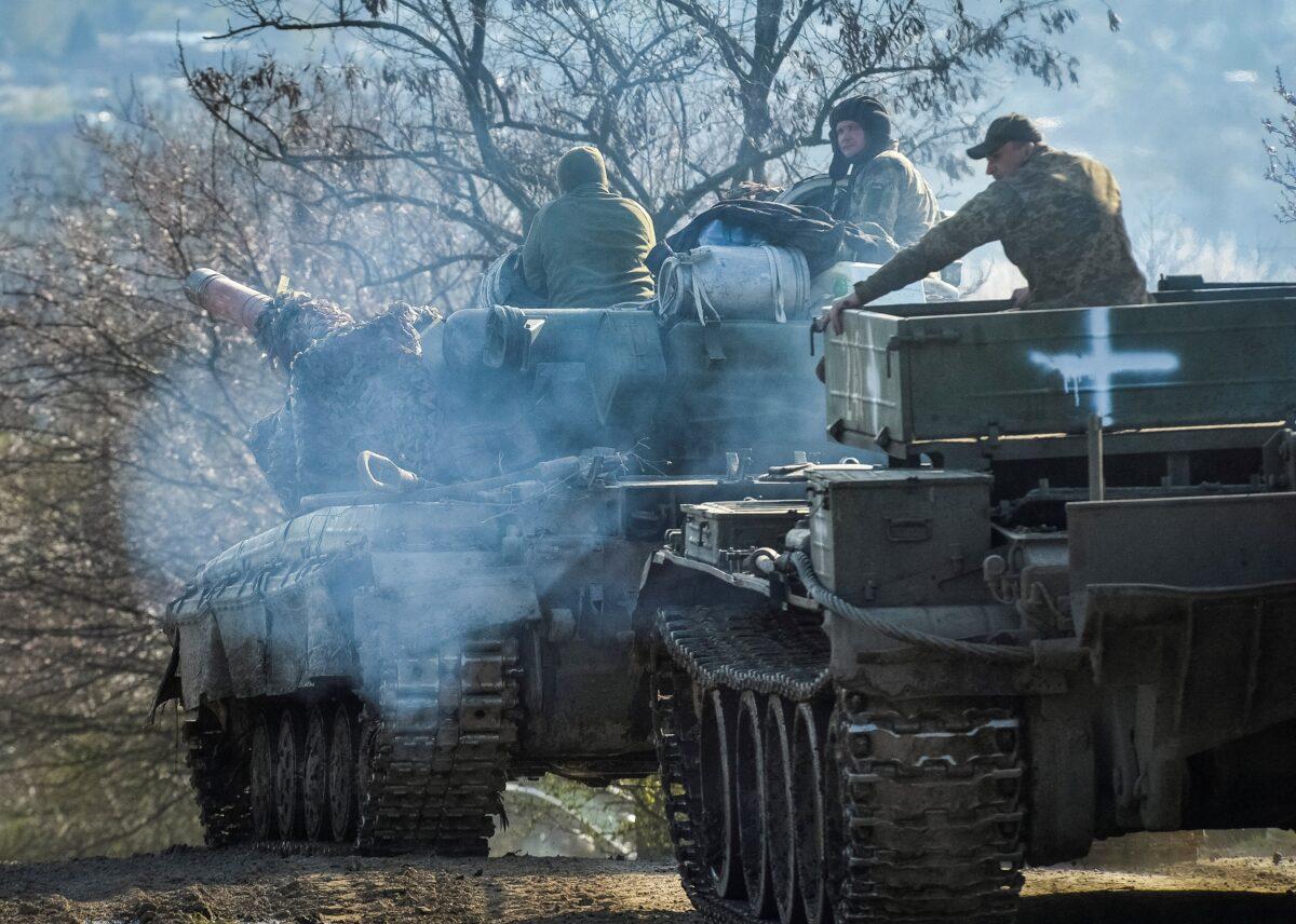 Ukrainian service members ride tanks near the front line city of Chasiv Yar, Ukraine, on April 10, 2023. (Oleksandr Klymenko/Reuters)
