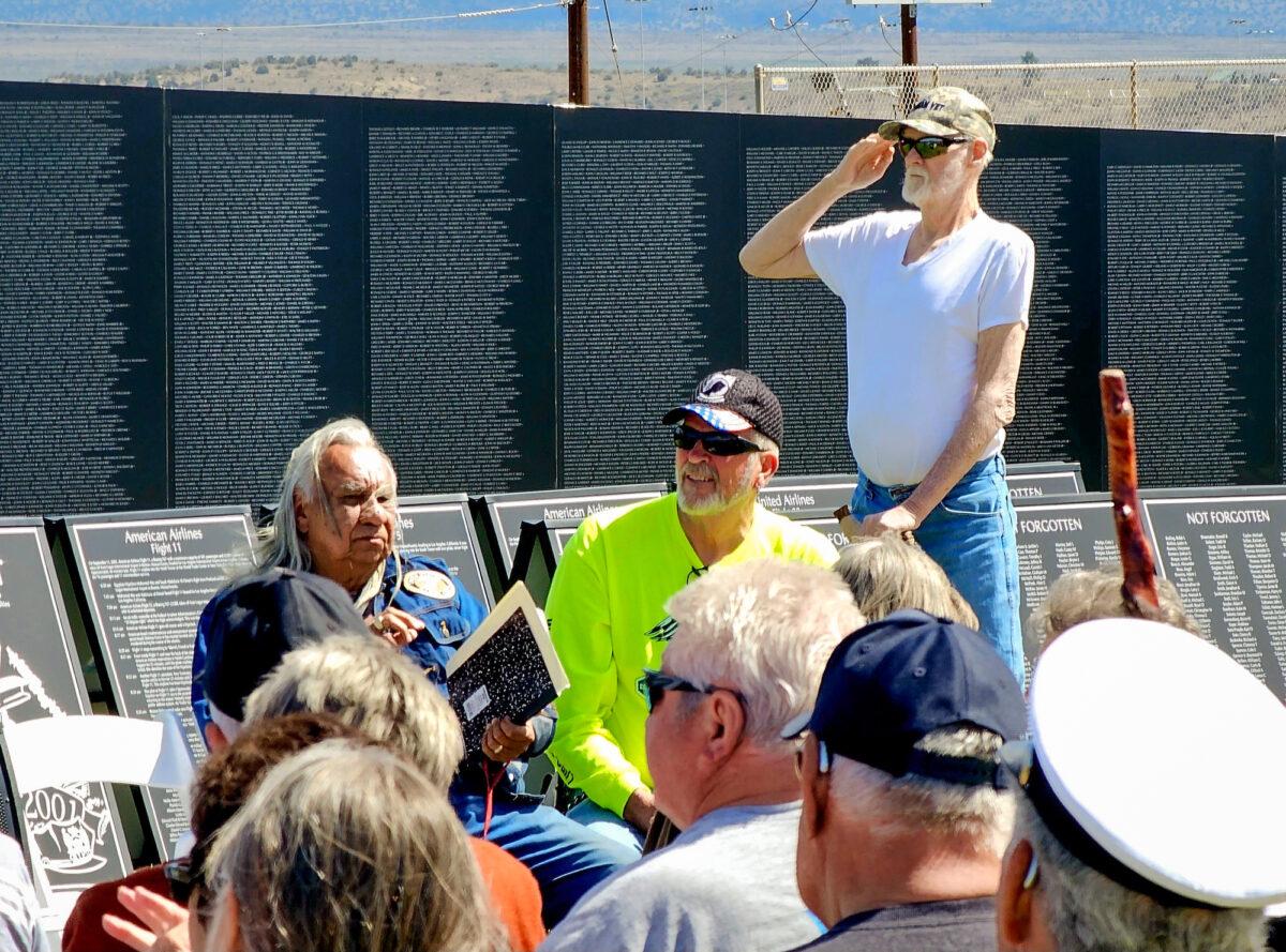 David Lucas, 71, diagnosed with several presumptive conditions associated with exposure to Agent Orange, salutes during the National Anthem at the traveling Vietnam memorial wall in Camp Verde, Ariz., on March 29, 2023. (Allan Stein/The Epoch Times)