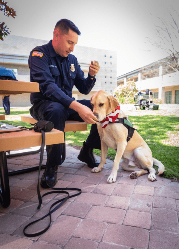 Orange County Fire Authority Firefighter Wade Munson and K-9 "Pax" sit at the agency's headquarter in Irvine, Calif., on April 10, 2023. (John Fredricks/The Epoch Times)