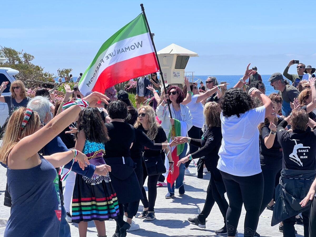 Iranian American women participate in a flash mob to raise awareness of human rights violations in Iran in Laguna Beach, California on April 8, 2023. (Rudy Blalock/The Epoch Times)