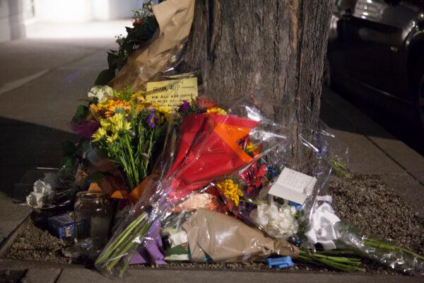 Flowers and notes in memory of Bob Lee at the corner of Main Street and Harrison in San Francisco on April 7, 2023. (Lear Zhou/The Epoch Times)