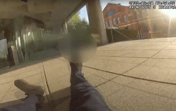 This image from Officer Cory Galloway's bodycam footage depicts him falling to the ground while he and his partner Nickolas Wilt, who is blurred out, were under fire from an active shooter at Old National Bank in Louisville, Ky., on April 10, 2023. (Louisville Metro Police Department/Screenshot via The Epoch Times)