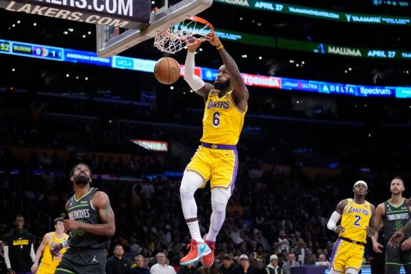 Los Angeles Lakers forward LeBron James (6) dunks over Minnesota Timberwolves guard Mike Conley, left, during the first half of an NBA basketball play-in tournament game in Los Angeles on April 11, 2023. (Marcio Jose Sanchez/AP Photo)