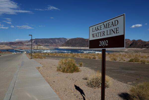 A sign showing where Lake Mead water level was in 2002 is posted near the Lake Mead Marina in Lake Mead National Recreation Area, Nevada, on Aug. 19, 2022. (Justin Sullivan/Getty Images)
