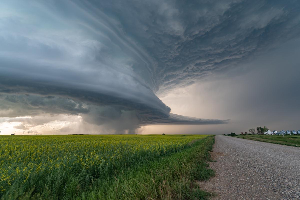 A spectacular storm structure hangs in the air near a country road. (Courtesy of <a href="https://www.facebook.com/5elementsxposure">Gunjan Sinha</a>)