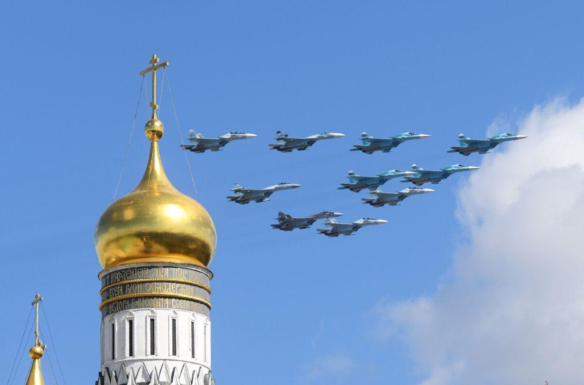 Russian Sukhoi Su-35 and Su-34 military aircraft fly above the Ivan the Great Bell Tower during a rehearsal for the Victory Day military parade in central Moscow on May 4, 2017. (Natalia Kolesnikova/AFP via Getty Images)