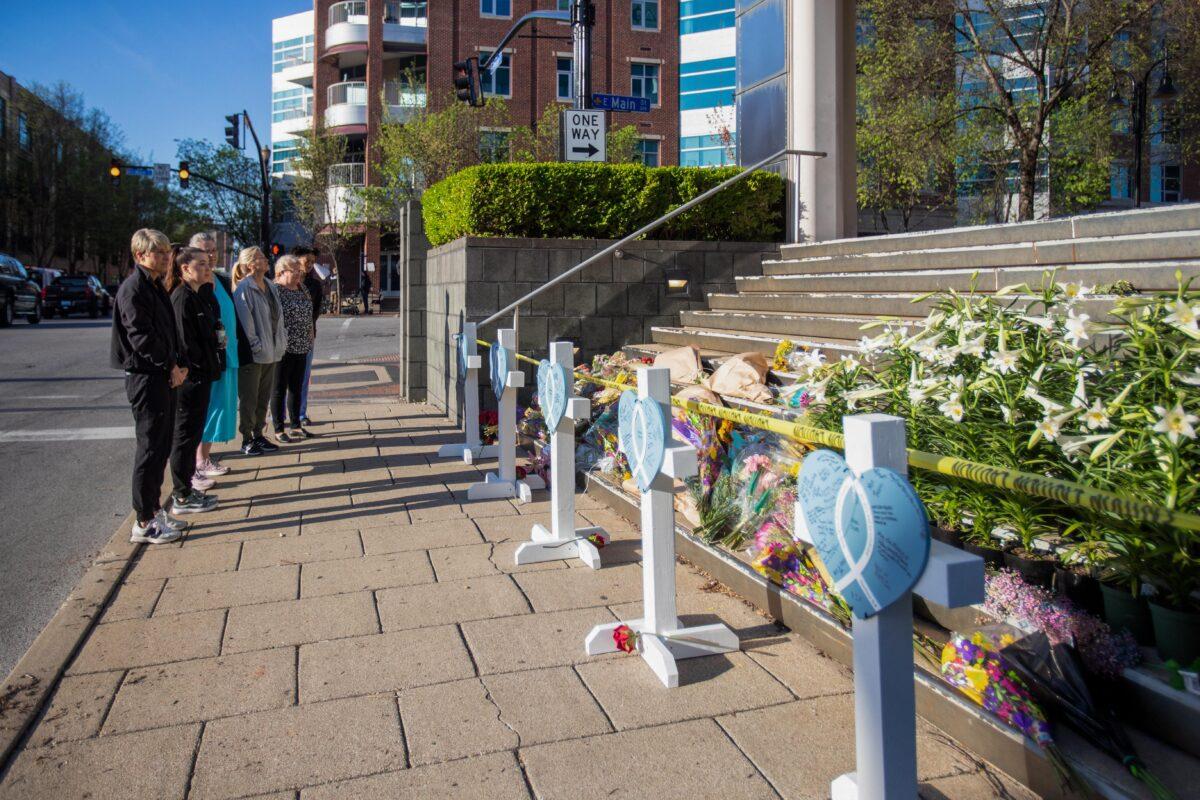People look at a makeshift memorial on the steps of the Old National Bank, the site of the April 10, 2023, shooting in Louisville, Kentucky, on April 12, 2023. (Leandro Lozada/AFP via Getty Images)