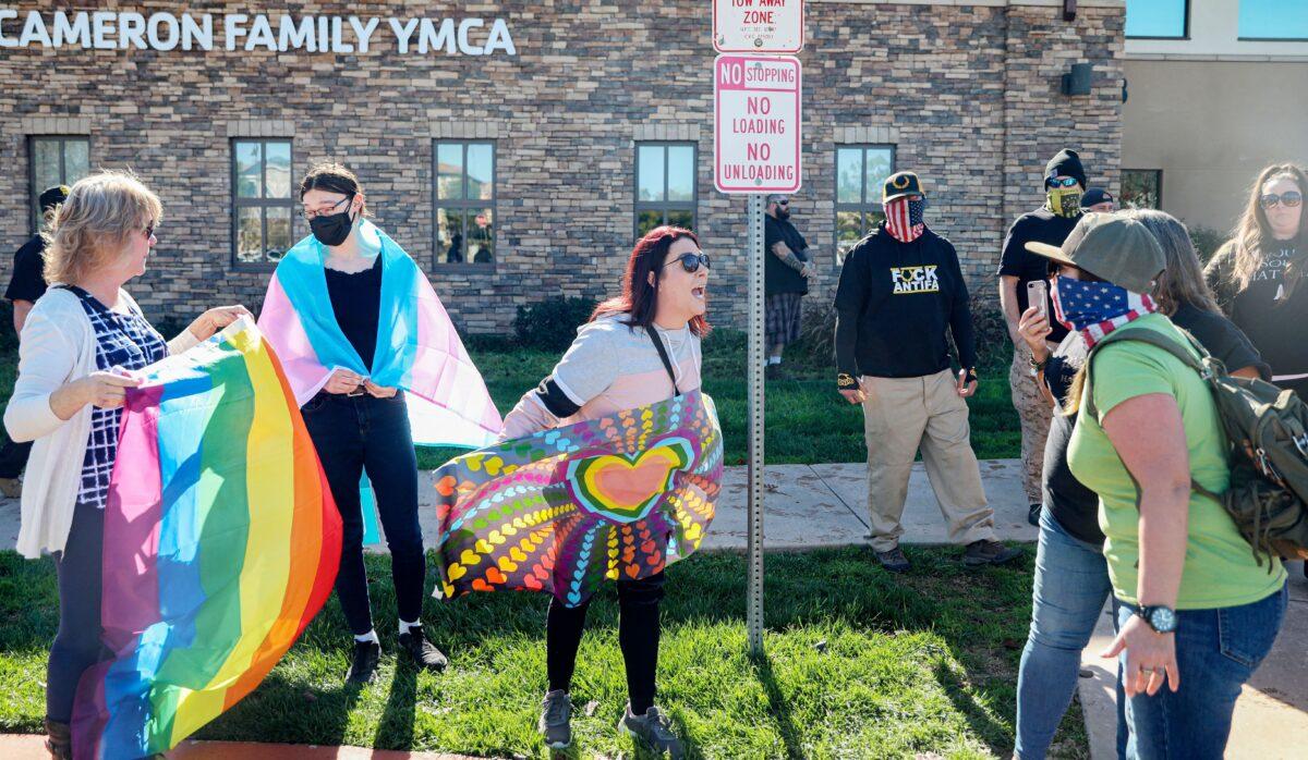 Activists face off against protesters rallying against a transgender individual using the female locker room at the YMCA, in Santee, Calif., on Jan. 21, 2023. (Sandy Huffaker/AFP via Getty Images)