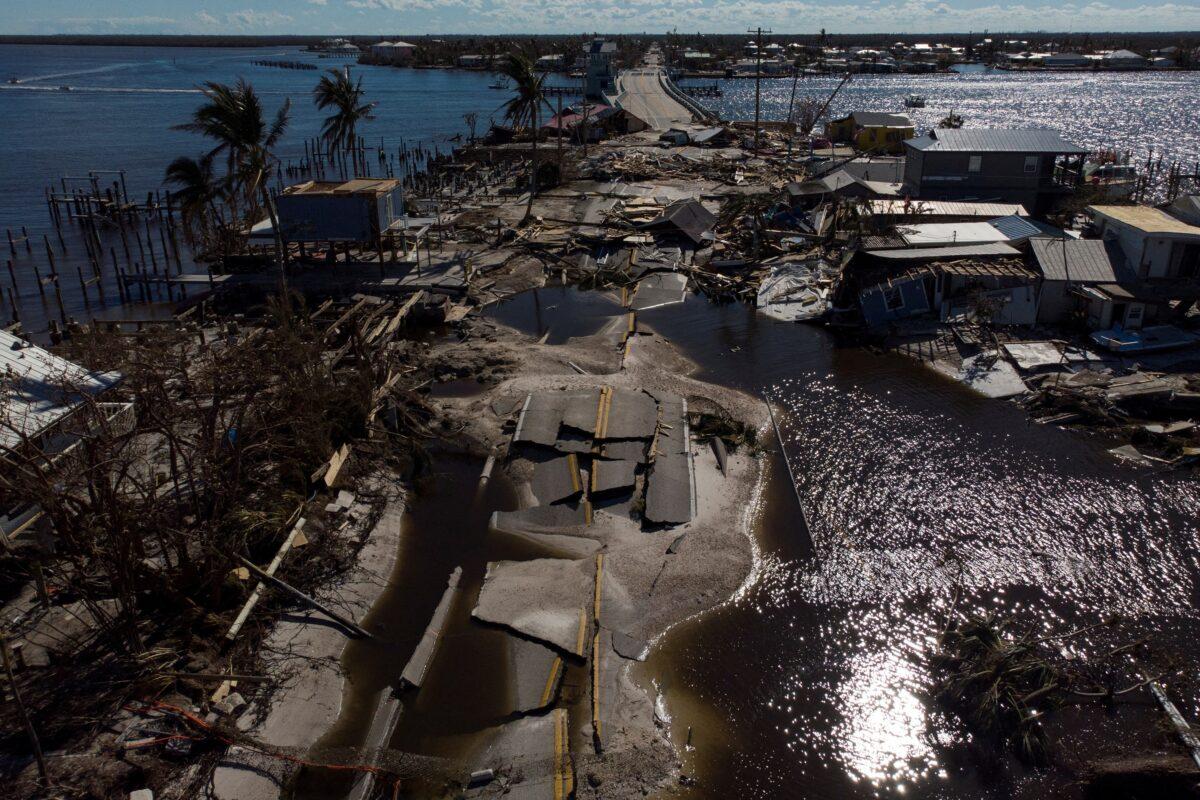 Hurricanes like Ian—its damage to the causeway between Pine Island and Matlacha pictured here on Oct. 2, 2022—require the state to have the most dependable electrical grid possible, state environmental regulators argue. (Marco Bello/Reuters)