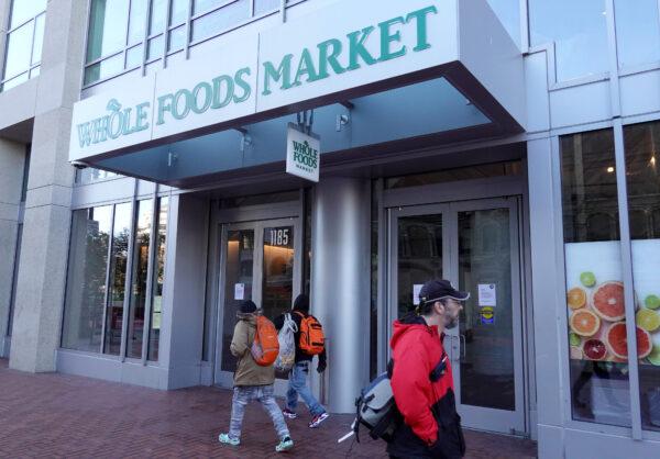 Pedestrians walk by a closed Whole Foods Market store in San Francisco on April 12, 2023. (Justin Sullivan/Getty Images)