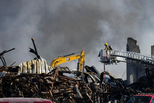 Firefighters pour water on an industrial fire in Richmond, Ind., on April 13, 2023. (Michael Conroy/AP Photo)