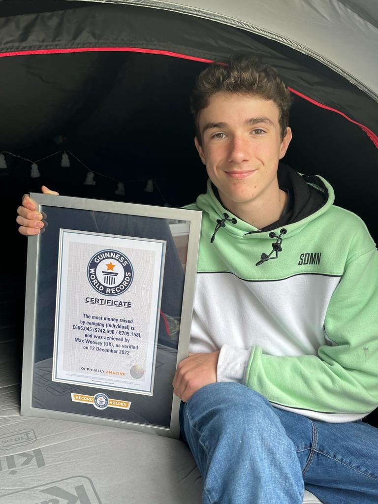 Max Woosey holding his <a href="https://www.guinnessworldrecords.com/news/2023/3/boy-in-the-tent-breaks-record-as-he-heads-inside-after-three-year-charity-campaign-742055">Guinness World Record</a> certificate for the most money raised by camping as an individual. (Courtesy of Rachel Woosey)