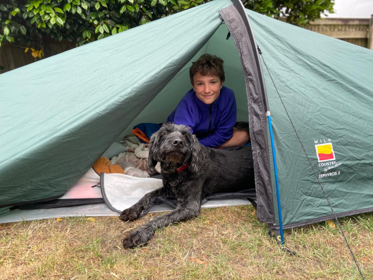 Max Woosey of Devon in southern England with his dog in a tent. (Courtesy of Rachel Woosey)