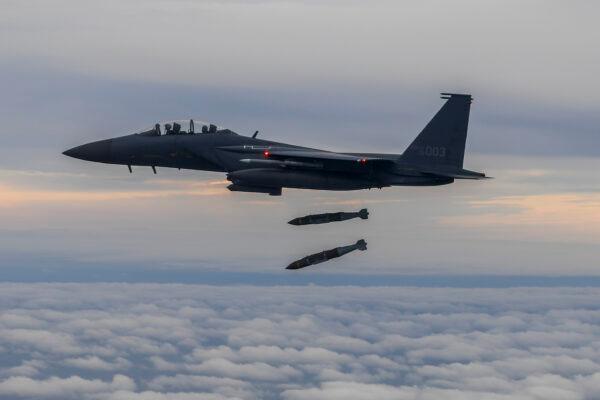 A South Korean F-15K fighter fires two Joint Direct Attack Munition (JADAM) bombs into an island target in response to North Korea's intermediate-range ballistic missile (IRBM) launch earlier in the day, on October 04, 2022. (Courtesy of South Korean Defense Ministry via Getty Images)