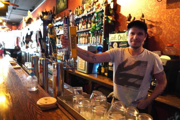 Bartender Shawnee Snaketail gets ready to pour a glass of Bud Light at the Bird Cage Saloon on April 13, 2023. (Allan Stein/The Epoch Times)