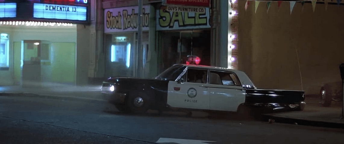 The '61 Ford Galaxy police car that's been destroyed by a hook and steel cable surreptitiously attached to the rear axle as a gang prank, in “American Graffiti.” (Lucasfilm Ltd./The Coppola Company/Universal Pictures)