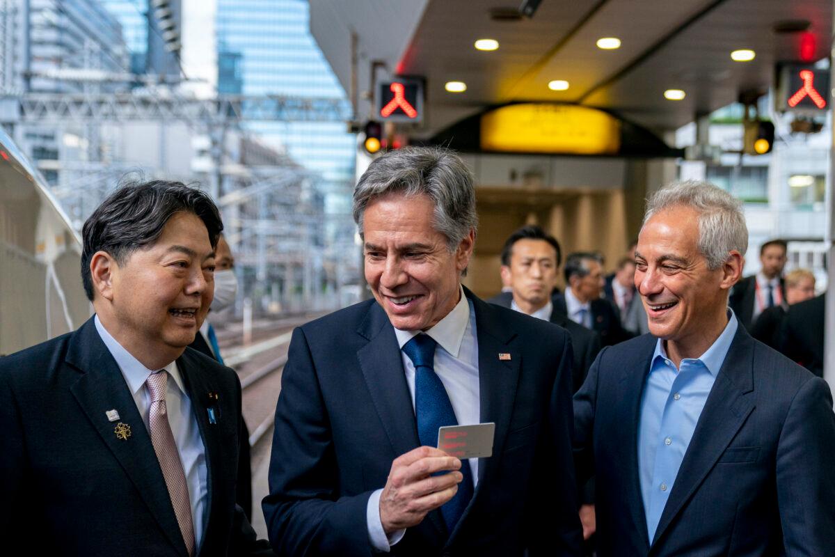 U.S. Secretary of State Antony Blinken (C), accompanied by U.S. Ambassador to Japan Rahm Emanuel (R), holds up his boarding card as he is greeted by Japan's Foreign Minister Yoshimasa Hayashi (L), as he boards a train at Tokyo Station in Tokyo on April 16, 2023, to travel to Karuizawa, Japan for a G7 Foreign Ministers' Meeting. (Andrew Harnik, Pool/AP Photo)