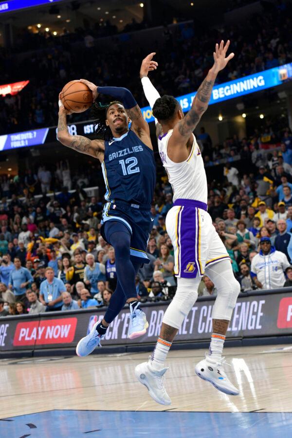 Memphis Grizzlies guard Ja Morant (12) shoots against Los Angeles Lakers guard D'Angelo Russell (1) during Game 1 of a first-round NBA basketball playoff series in Memphis on April 16, 2023. (Brandon Dill/AP Photo)